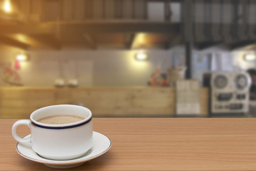 coffee on wooden table with abstract blur of counter bar