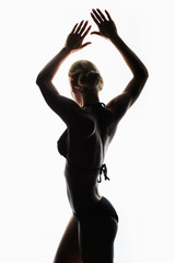 female silhouette.young sexy woman in bikini.girl with a sports body
