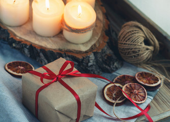 Close-up of Christmas gift in the candlelight