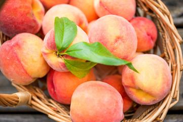 Close up of a basket of ripe peaches