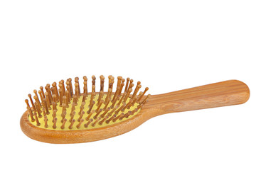 wooden bamboo comb for hair care on white