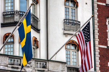 Building facade with Swedish and US flags