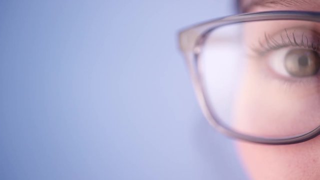 View of a Detailed close up of an brown eye behind glasses in high definition