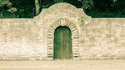 Old Wooden Door with Stone Round Arch - 123068903