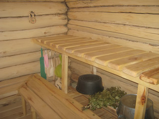 wooden bath with bed curtains and a bench