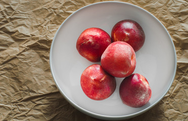 Group of Fresh Organic Peaches on a Craft Paper