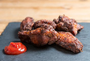Chicken wings with sauce and golden French fries potatoes