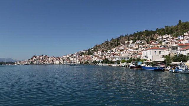 Passage of sailing vessel along the coast of Poros island, Aegean Sea, Greece, view from yacht boat.