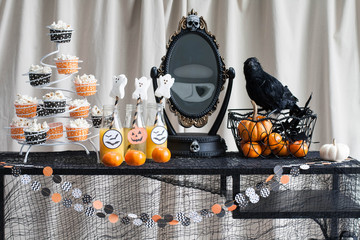 A tabel decorated for halloween party; healthful snacks and drinks, no candy 