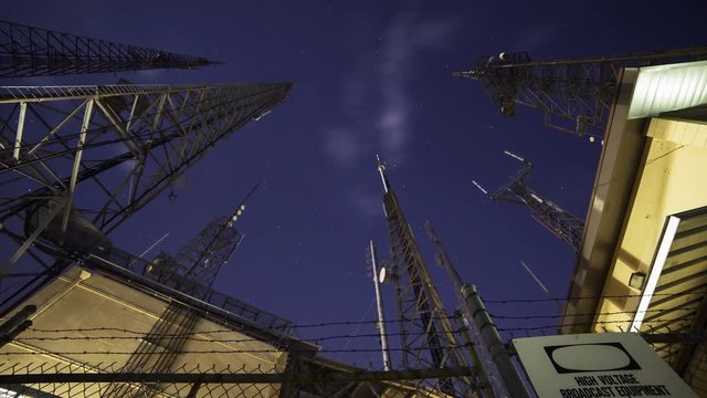 Time Lapse with zoom in motion of broadcast radio tower at night shot through storm clouds at Mt. Wilson, California