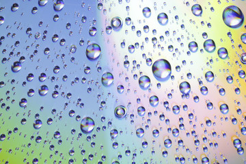 Background of colored water drops on glass