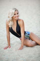 Fototapeta premium Sexy bikini model at sand beach