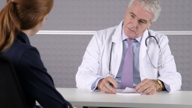 Doctor writing medical prescription