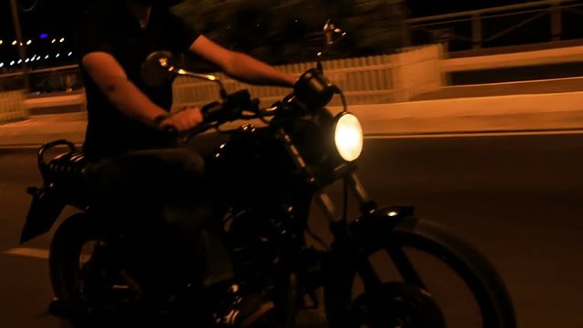 Closeup Guy in Helmet Speeds on Motorcycle along Asphalt Road