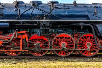 Fototapeta na wymiar Side view on CSD, Czechoslovak steam locomotive, with huge, red spoke main wheels