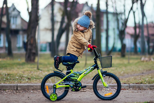 Cute little boy on bike in autumn park