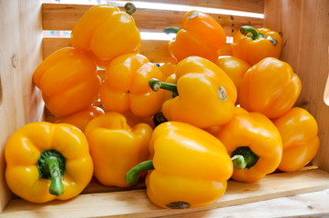 Wood crate with yellow bell peppers