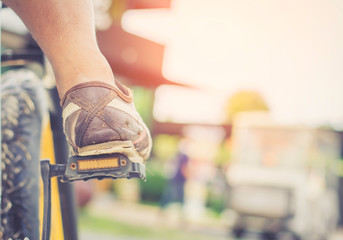 Fototapeta premium Selective focus foot on pedal of bicycle. active summer