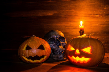 pumpkins with skull on wooden background with copy space