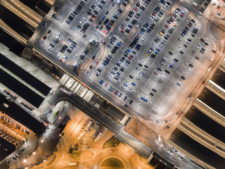 Transportation, cars on big parking at night. Aerial view in Krakow, Poland. Railway station and autobus station