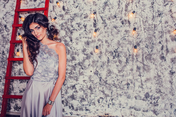 Elegant beautiful brunette posing, smiling, looking at camera. S