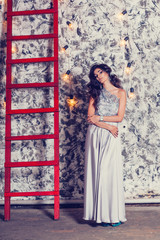 Obraz premium Elegant beautiful brunette posing, smiling, looking at camera. S