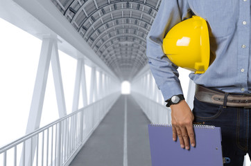 Engineer holding yellow helmet