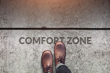 Comfort Zone Concept, Male with Leather Shoes Steps over a word