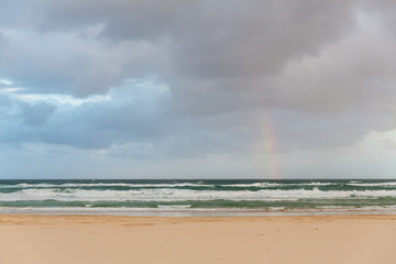 Rainbow over the ocean on the coast of Fraser Island - largest s