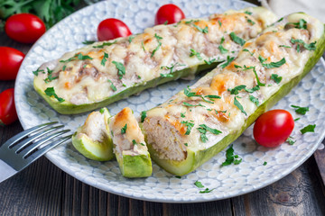 Zucchini boats stuffed with ground meet on a plate, horizontal