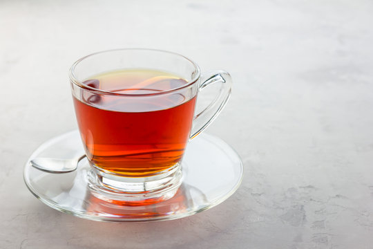 Healthy herbal rooibos red tea in glass cup, copy space