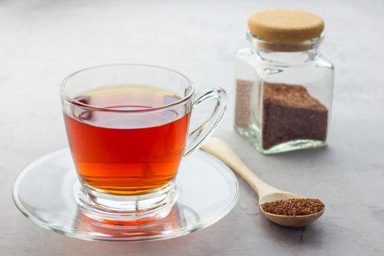 Cup of healthy herbal rooibos red tea in glass cup