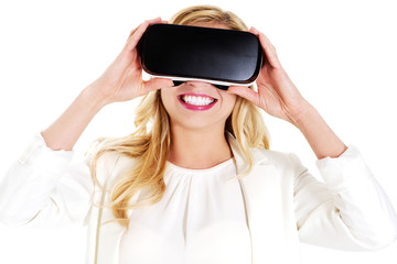 Girl wearing virtual reality goggles isolated on white.