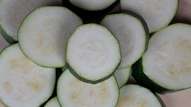 Sliced zucchini courgette vegetables. turntable closeup shot.