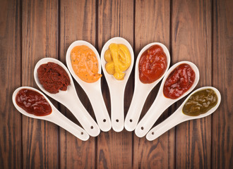 different sauces are on the wooden background