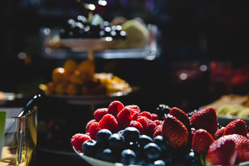 Grocery decoration. Tasty berries illuminated by arificial light