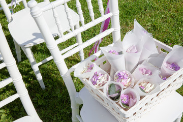 White basket with envelopes full of violet petals