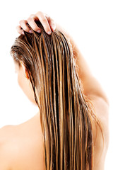 Naklejka premium Woman applying hair conditioner. Isolated on white.