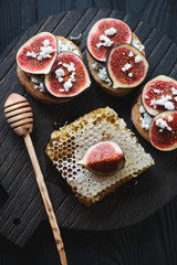 Closeup of bruschettas with fig fruits, honey and cottage cheese
