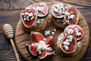 Bruschetta with fig fruits, honey and cottage cheese, closeup
