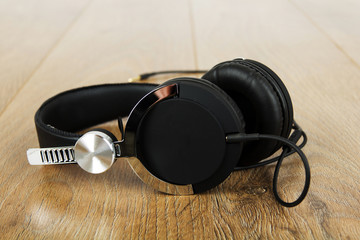 Pair of headphones on a rustic wooden surface