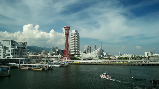 View of Kobe bay with Port Tower blue sky and speed boat. 2016
