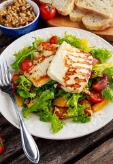 Grilled Halloumi Cheese salad witch orange, tomatoes and lettuce. healthy food