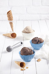Vanilla and chocolate ice cream bowls and cones.