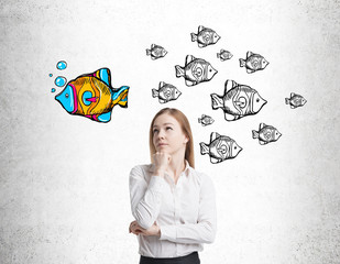 Blond girl and fish sketches on concrete wall