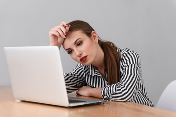 Exhausted businesswoman working on computer