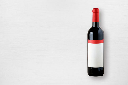 Red Wine Bottle On White Table Top View