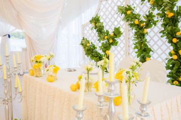 Wedding table decorated with lemons and white candles