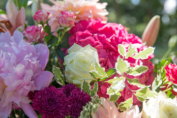 Sunshines on a rich spring bouquet of roses and ranunculus