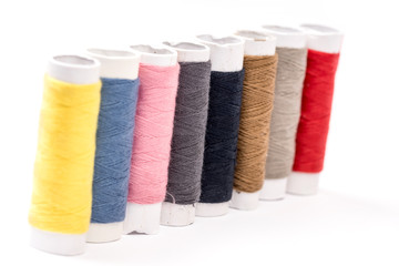 Colorful threads on the white background
